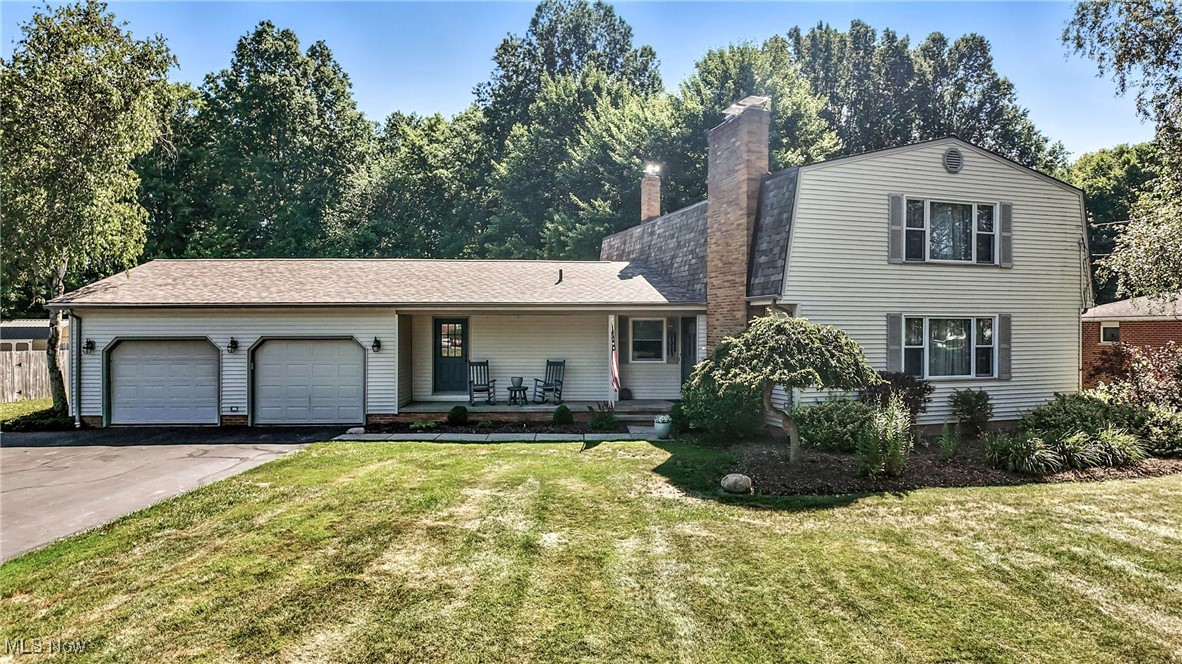 Welcome to this charming 3-bedroom home situated on a sizable lot in a lovely Howland neighborhood. An inviting front porch leads you into the home where you will quickly see a floor plan that offers comfortable living space with plenty of room for entertaining. An exceptionally large living room, with a gas fireplace and plenty of natural light from the picture window leads to the dining room with a new sliding glass door. The recently redone kitchen boasts granite counters, glass front cabinets, a large pantry and a comfortable eating area with sliding doors that lead to the outdoor deck. New dishwasher (2024), gas range (2023), refrigerator and microwave remain with home. A substantial family room is graced with sizable windows overlooking the back deck and yard, with easy access to the laundry/mud room and the recently updated powder room. Hardwood stairs lead to the second floor where you will find a beautiful and cozy master suite with a gas fireplace, walk-in closet, built in bookcases and ensuite complete with an oversized shower. There are two additional bedrooms and a full bath which was recently remodeled. The basement includes a rec room with a bar and sink, new carpet, and plenty of storage space. A slate pool table/ping pong table remains with the home. A beautifully landscaped outdoor space includes a grilling station with a natural gas grill and a charcoal grill that remain with the home, great for entertaining. The home boasts several updates including a new roof (2020), new air conditioner (2019), new water heater (2025). Schedule your showing today!