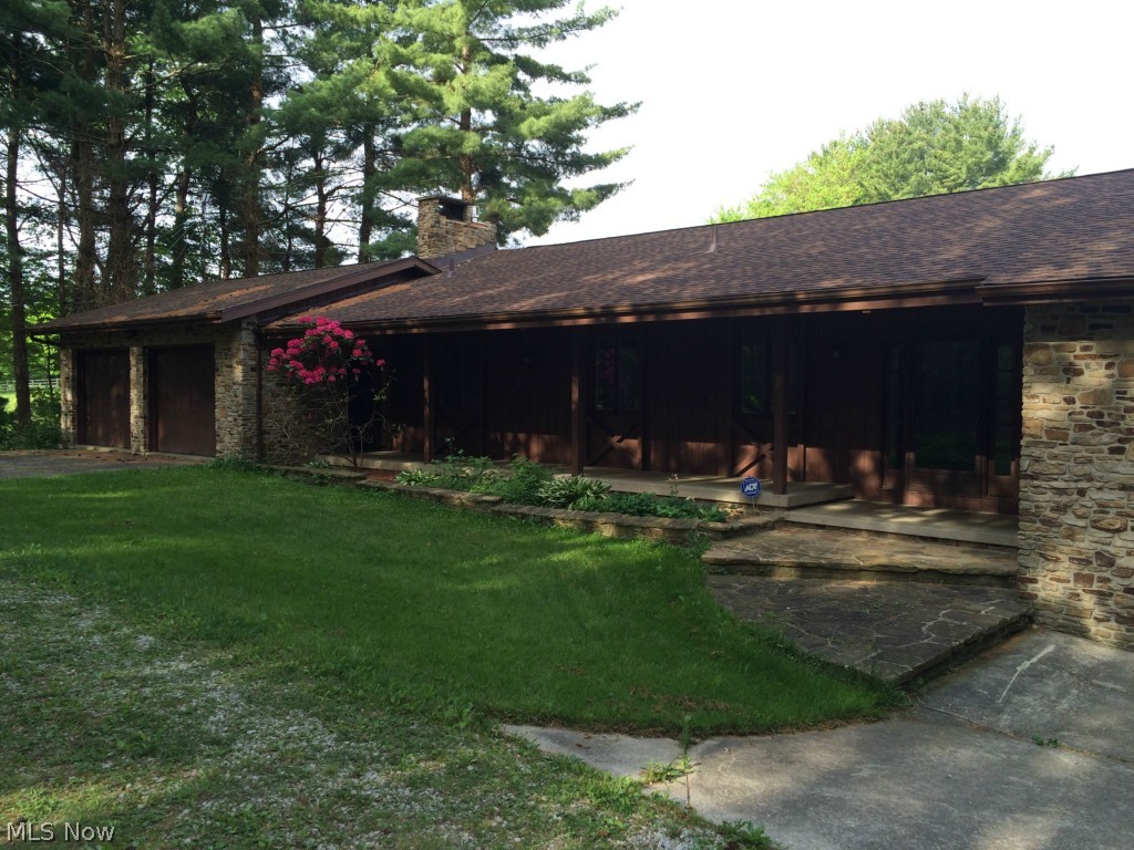 Charming, private lake-front ranch house situated on an idyllic wooded lot with over 8 acres of land! This house has two full levels of living space, a 4-car garage (each end of the house has a two-car attached garage. One of the bays in the left-most garage is used up by utility room space), a deck that covers the span of the entire house off the main level, a lovely lake-front concrete patio with diving board. This property has a greenhouse & a two-stall horse barn well-equipped for the equine enthusiast. The lot also contains pasture, lawn, and raised-bed garden spaces. The seller has made some recent updates. New roof (2013); well (2013); activator for septic (2013); radon mitigation unit installed (2012). The lower-level of the home is need of some cosmetic renovations following a severe weather event in 2013 that brought lake water into the home. The damage on that level has been mitigated & it is prepped for renovations. Oil and gas income. Free gas owned by seller to t