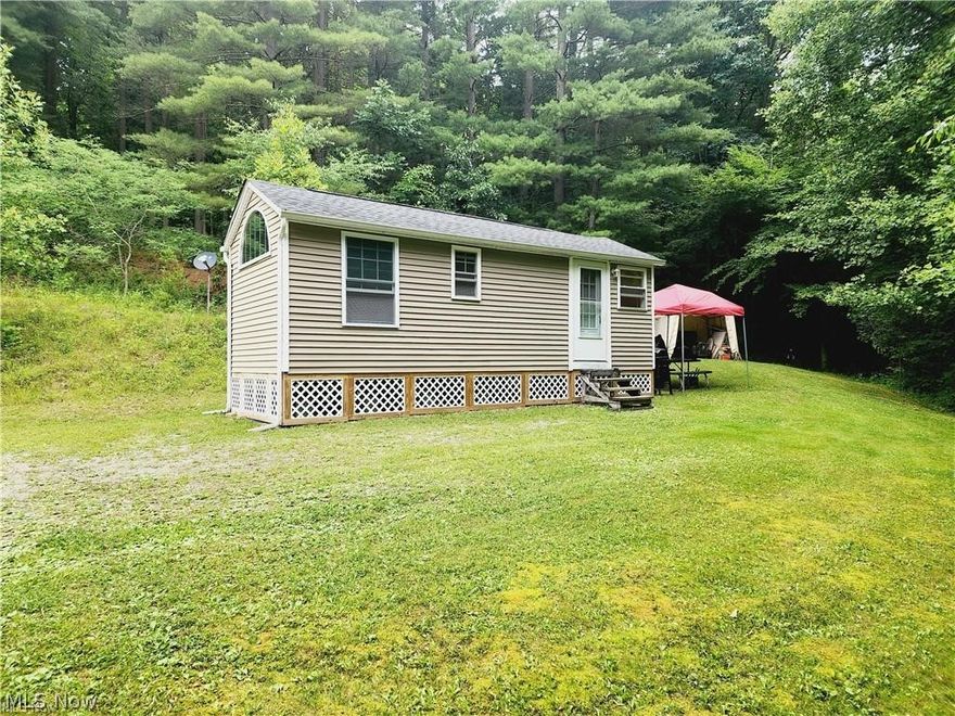 Located 15 min away from Salt Fork Lake sits a secluded piece of land consisting of just shy of 6 acres with mature timber that not only provides a natural habitat for wildlife, but also contributes to a pieceful, private get away. Included with this property is a quiant little cottage type structure offering one bedroom, full bath, living area and kitchen. Cottage has a full electric hook up with a 200 amp service and a storage tank for water that is hard lined in and pressurized by a RV pump. Come and take advantage an an opportunity to own a hidden piece of simplicity.