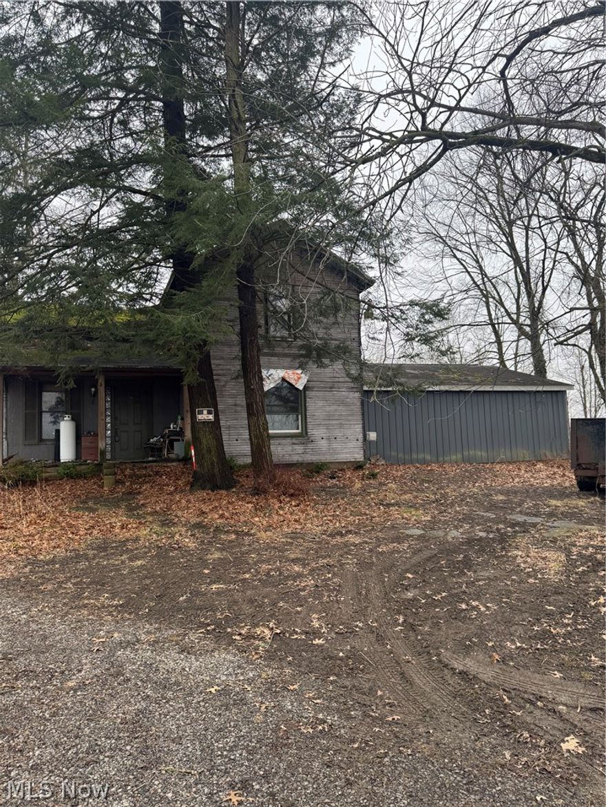 On 1.8 Acres, This home does need work but the Seller has done almost all of the demolition down to the studs.  It is a blank slate with the possibility of the new owner making this home to be what the new owner/buyer wants.  Over 100 years old this home has 3 maybe 4 bedrooms if you want.  There is an unfinished room in the back that was going to be a Master Bedroom with a full Bath, you could use this room as a Family Room also.  There are a LR, DR, and Kitchen stairs to the 2/3 Bedrooms and Full Bath.   The separate Large garage is detached with an attached 2 car garage.  All Buyers and Realtors will have to sign a "Hold Harmless". saiver.