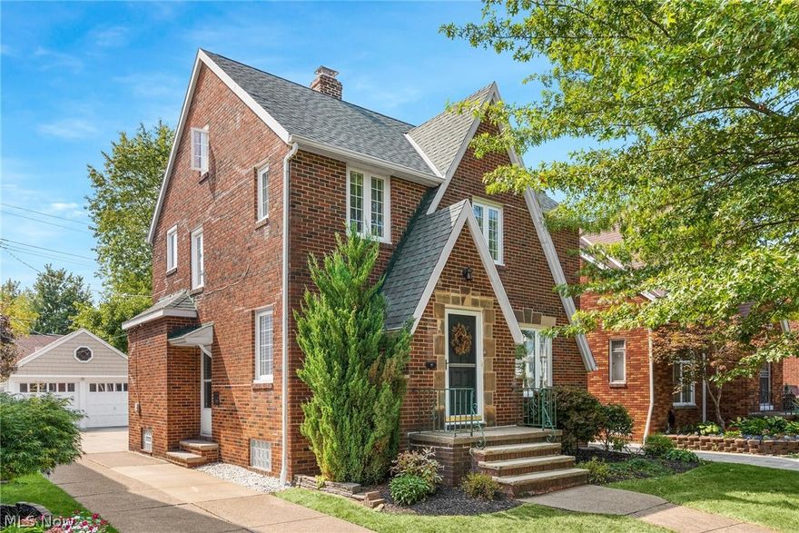 Welcome home to this amazing move-in ready 3 bedroom 1.5 bath brick colonial North of the Blvd in Euclid. So much character and charm throughout. The inviting front entry vestibule with closet and storage bench leads you into the open floor plan of the stunning living room with stone mantel fireplace and into the spacious dining room both with gleaming hardwood floors, coved ceilings and natural light. The adjoining large open kitchen with new flooring boasts beautiful cabinets, plenty of storage, and additional seating at the bar height peninsula.  The cozy sun room off the kitchen is the perfect spot to relax. The wrought iron staircase leads you upstairs to the newly renovated full bath, large master bedroom with hardwood flooring; a second bedroom with built-in shelving and contoured nook and balcony overlooking the back yard. The cozy third bedroom is complete with access to third floor 22x12 enormous storage attic.  The basement boasts a huge family rec area with fireplace, spaci
