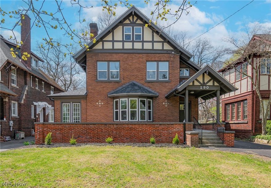 Welcome to this enchanting historic home nestled in the heart of Akron, Ohio just minutes from Highland Square! This property is situated on the prestigious N Highland Ave and offers the perfect blend of timeless charm and modern convenience. A one of a kind 4 bedroom, 1.5 bathroom Tudor boasting classic architectural details, including original hardwood floors and crown molding. You will be greeted by an oversized front porch stretching the length of the home and offering double entries. The foyer opens up into a stunning main level that is perfect for entertaining. The living room features a fireplace and a large bay window overlooking the front porch. Continue into a sun room with built in shelving or the formal dining room with a beautiful chandelier and plenty of natural light. Find your culinary inspiration in your renovated kitchen complete with granite countertops, stainless steel appliances, and custom cabinetry. The nearby back entry includes built-in coat and shoe storage along with access to the one car attached garage. Venture upstairs to find three bedrooms, a spare room, and a beautiful full bathroom. The spacious owner's bedroom offers two closets, one with motion lights and extra storage space. The third level features the fourth bedroom and an additional spare room, great for a play room. Enjoy outdoor living in your private backyard with a patio area, ideal for summer barbecues and gatherings. Notable updates include: flooring, kitchen, backsplash, A/C, updated electrical, built-in closet, and updated plumbing. One year home warranty included for your peace of mind. Highland Square is a vibrant and eclectic neighborhood known for its unique shops, trendy restaurants, and lively arts scene. Residents enjoy easy access to parks, schools, and major highways, making it a desirable location. Don't miss this opportunity to own a piece of Akron's history. Schedule your showing today and experience the charm of 190 N Highland Ave!