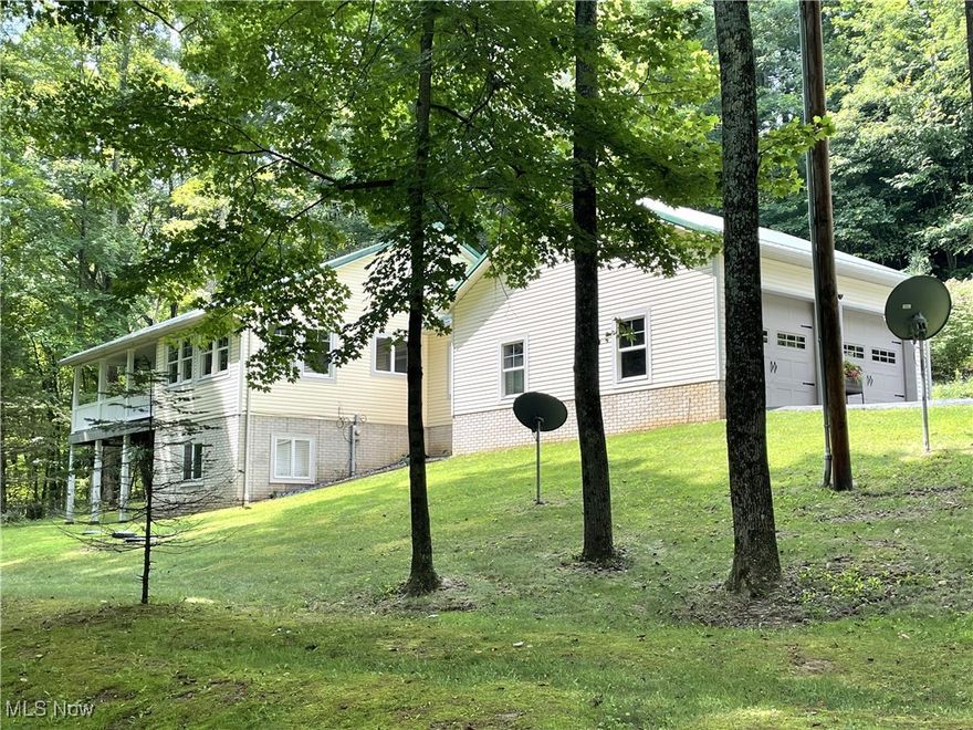 Total Peace and Serenity to be found with this Immaculate 3BR-2.5BA ranch home tucked in on 2 Very private acres!  Quality built in 2009, this meticulously maintained home has so much to offer.  As you wind up the paved driveway, you will first see the 20’x20’ barn/workshop area with double overhead doors which provides excellent storage for lawn equipment or recreational vehicles.  You will then approach the attached oversized 24’x28’ garage.  Meander around to the welcoming entry door and you will enter the mudroom/breezeway which connects the house and garage.  Upon entering the home, you will be pleased with the hardwood floors, solid panels doors and woodwork which first greets your eyes. The first floor contains the gorgeous, updated kitchen with quartz countertops which opens to the large living room with vaulted ceilings, the dining area with it the walls of windows overlooking the wooded property, the master bedroom w/walk-in closet and private bath, first floor laundry room and half bath.  Head on down to the finished walk-out lower level and you will find an Immense family room, full kitchen, 2 more bedrooms, all with cork flooring and a full bath. There is a portion of unfinished area for storage in the mechanicals room. The majority of the home has been recently painted. Outside the home is a back deck w/a Trex floor, perfect for outdoor grilling, as well as a 2-story covered deck w/Trex floor and a covered porch below on the front of the home to while away the hours and enjoy nature.  The home comes with all appliances, including washer and dryer. There is also a whole house, automatic start generator for piece of mind.  Oh and wait, there is also a small storage barn that the owners used as their chicken coop should you desire to do the same.  Pristine condition, seclusion and privacy, check it out!