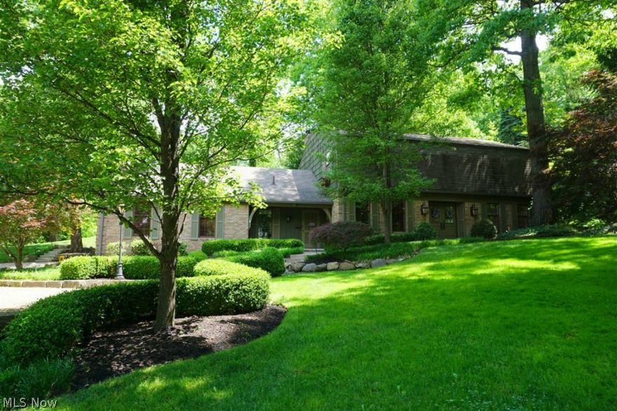 This prominent Avondale home on a prime .87 acre lot brims with character! 3,576 total sqft of living space with 3-4 bedrooms and 2.5 baths. Recently painted throughout with newer hardwood floors and fresh carpet.  Large entrance foyer leads to a dramatic two-story Great Room with fireplace and new staircase to the second floor. Versatile family/hearth room provides dining or additional living space. Schrock cherry kitchen has upscale appliances and a large island. First floor master bedroom offers dressing area and spacious bath.  Two bedrooms upstairs share a newly renovated full bathroom.  Additional living space in the basement adds a large recreation room, bonus room (or 4th BR), full bath, and laundry.  Gorgeous park-like yard has beautiful brick patio with water feature and a play house.  This is a very special home in the heart of Avondale!