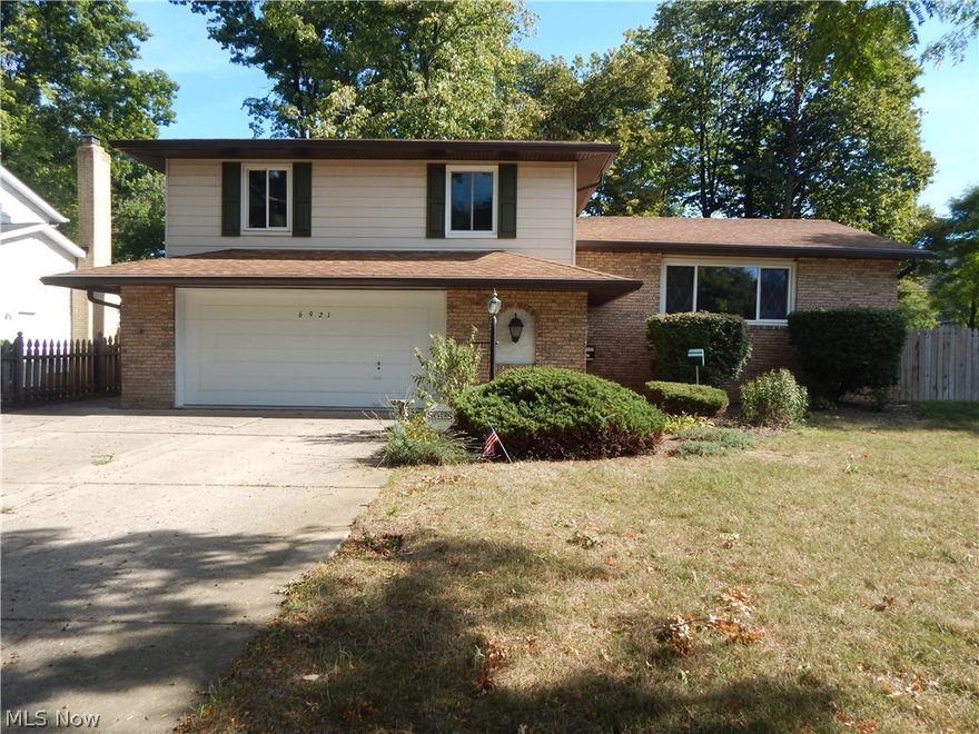 Spacious split level with basement! Brand new laminate wood flooring in living room, family room, dining room, stairs, and all bedrooms. Fresh paint throughout. Eat in kitchen with new vinyl flooring and brand new range, refrigerator, and dishwasher. Large family room with fireplace and sliding doors leading out to fully fenced in yard. Formal dining room. Large owner's suite with full bath. 2 additional spacious bedrooms. Stanek windows throughout. All appliances stay, including washer and dryer. 2 car attached garage. Security system. Great location! 1 year HMS warranty. Don't miss out!