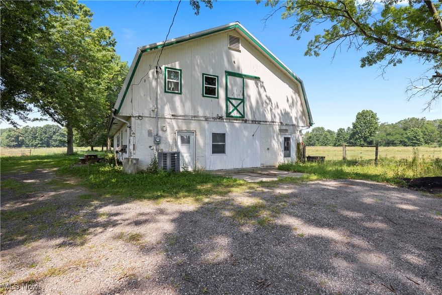 Discover your own slice of country paradise on this remarkable 41.37-acre farm property that offers endless possibilities. This unique barndominium combines rustic charm with modern comfort, featuring 3 bedrooms and 2 full bathrooms in 1,275 square feet of thoughtfully designed living space. The heart of this property is a converted gambrel barn that serves as your home base, complete with a huge loft perfect for entertaining guests, setting up a workshop, or simply storing all those things you swear you'll need someday. The main level flows seamlessly and includes a convenient garage door access and 4 additional stalls for whatever your heart desires. Step outside to your private patio, surrounded by mature trees that create a peaceful, secluded atmosphere. The outdoor amenities are truly impressive - a 10-stall horse stable with wash rack means you can house a small cavalry, while the massive 80x180 indoor arena barn gives you room to ride year-round, complete with 3 stalls and generous overhang roofs for additional covered space. The 50x120 steel pole barn shop is a dream workspace, featuring a lift, concrete floors, soaring 20-foot ceilings, and dual roll-up doors. An 18-foot overhang provides extra covered area and includes a shavings bin for convenience. Multiple pastures with wide gates and electric fencing offer flexibility for livestock or other agricultural pursuits. This former grass-fed beef ranch sits peacefully back from the road, providing privacy and tranquility while remaining accessible for your daily needs.