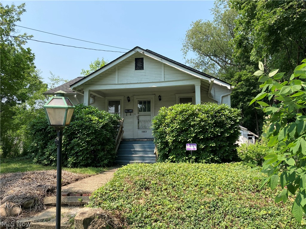Cute Bungalow on a dead end street with mature trees that sits beside the Goodyear Metropolitan Park. This home has been in the same family since it was built. The house has 3 bedrooms and 1 1/2 bathrooms with a two car detached garage and an attached carport area where you can lounge on your furniture and enjoy the view and peace on this quiet street. The roof is only one year old. Under all of the carpeting is hard wood flooring, which are probably in good shape since the owners did not have any pets. The wood trim is beautiful as you enter the home into the family room area. The lower level has a fruit cellar and ample storage. The washer/dryer, stove, and refrigerator (new) are all staying with the purchase of this home. This home is situated in the Ellet Schools. The house is sold in AS-IS condition. Come and view this one of a kind home!