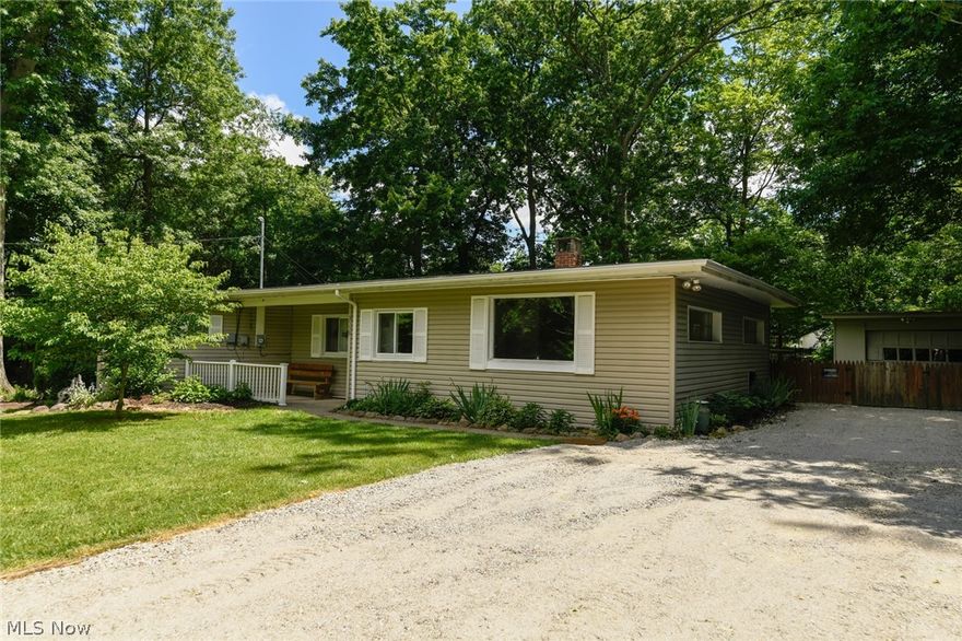 Looking for more room from your neighbors while still having the convenience of living in the center of town?  How about a double lot, park-like backyard with a tall privacy fence in a quiet neighborhood?  Located near the center of Stow and within walking distance of the city schools you may find this spacious ranch to your liking!  The living room has a beamed ceiling, fireplace, and a wood panel decor throughout, giving it a rustic welcoming feel.  Enjoy peaceful days while dining in the larger eat in kitchen with newly replaced flooring and countertops (2021).  Guests will appreciate the conveniently located half bathroom between kitchen and living room.  The hallway has a common area that could be used as a reading nook, small office, or study room.  Each of the 3 bedrooms has had new flooring installed (2021) and storage is no problem with this house!  Above the entry to each bedroom are hidden storage compartments and located in key areas (living room, bathrooms, and in the main