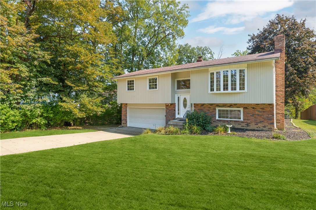 Welcome to this bright, fully updated and move-in-ready 3-bedroom, 2-full-bathroom home, tucked on a treeshaded Brunswick street! A vaulted great room with dramatic exposed beam, warm laminate floors, and a broad picture window sets an airy, welcoming tone. The open dining area flows to a large sun-splashed deck, perfect for entertaining, and the backyard comes fully loaded with the storage shed, trampoline, and grill. The fully updated kitchen with new appliances, cabinets and flooring is accented by a striking brick wall and offers ample cabinetry, prep space, and a handy breakfast ledge. Three comfortable bedrooms with new flooring and an updated full bathroom complete the main level. The finished lower level extends your living space with a family room that is adorned by a stone gas fireplace, second full bath, laundry room, and additional storage areas. Outside you will find a spacious attached 2-car garage and wide driveway. Mature trees throughout the property provide privacy and ample curb appeal. Other notable updates include all new exterior and interior doors, fresh paint, roof tune-up, updated plumbing, new flooring & baseboards, and the deck has been updated and painted. With being minutes to schools, parks, shopping, dining, and I-71, a life of convenience awaits you!