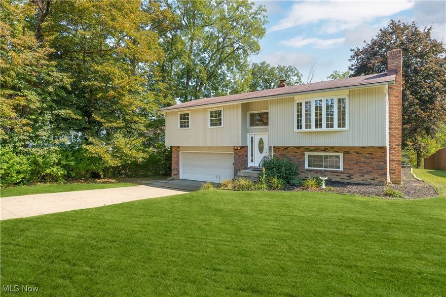 Welcome to this bright, fully updated and move-in-ready 3-bedroom, 2-full-bathroom home, tucked on a treeshaded Brunswick street! A vaulted great room with dramatic exposed beam, warm laminate floors, and a broad picture window sets an airy, welcoming tone. The open dining area flows to a large sun-splashed deck, perfect for entertaining, and the backyard comes fully loaded with the storage shed, trampoline, and grill. The fully updated kitchen with new appliances, cabinets and flooring is accented by a striking brick wall and offers ample cabinetry, prep space, and a handy breakfast ledge. Three comfortable bedrooms with new flooring and an updated full bathroom complete the main level. The finished lower level extends your living space with a family room that is adorned by a stone gas fireplace, second full bath, laundry room, and additional storage areas. Outside you will find a spacious attached 2-car garage and wide  driveway. Mature trees throughout the property provide privacy and ample curb appeal. Other notable updates include all new exterior and interior doors, fresh paint, roof tune-up, updated plumbing, new flooring & baseboards, and the deck has been updated and painted. With being minutes to schools, parks, shopping, dining, and I-71, a life of convenience awaits you!