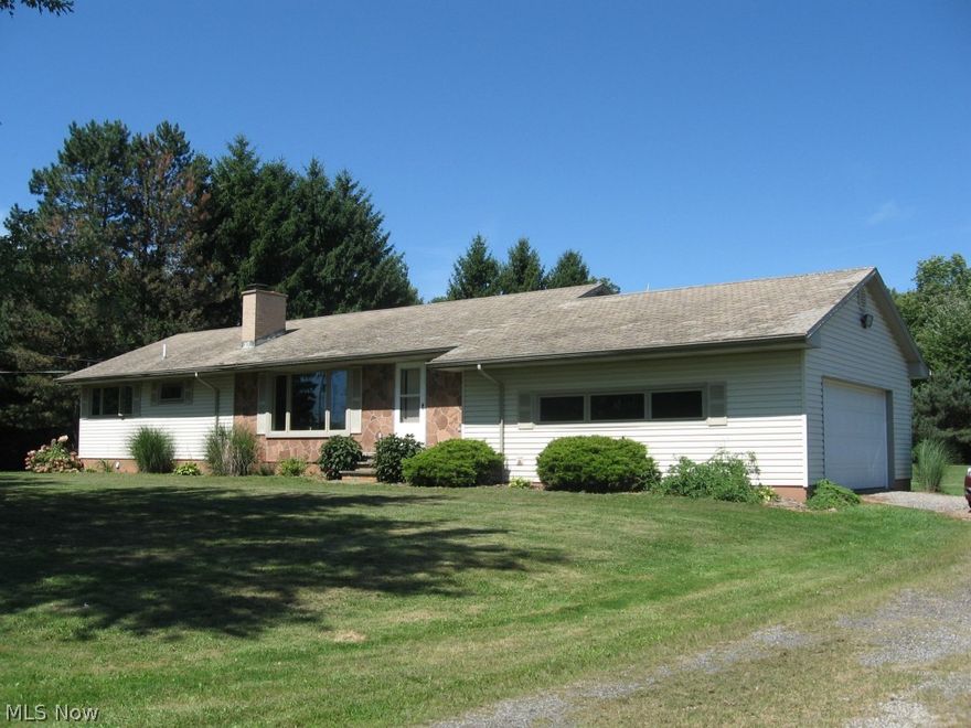 Move to the country to this  wonderful custom built ranch on 9+ rolling acres. The original owner built this with cherry wood paneling in the huge Living room & Dining room & solid construction throughout. The eatin kitchen has wood cabinets. stone backslash & lots of counter space. The full bath has been completely remodeled. The BDRMS have large closets, & HDWD floors ,Master & another BDRM have ceiling fans. The full basement has a fireplace, fruit cellar, & laundry area. The home has all new windows & new paint in the LR & hall. There is a 220 line & sink in garage. The covered patio overlooks the rolling acreage  in back. Quick Occupancy!