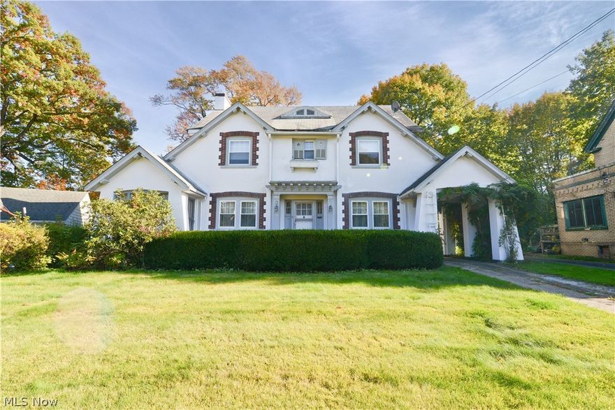 Step back in time when you pull into this turn of the century Colonial. Nestled on Youngstown's North side in the heart of the Crandall Park-Fifth Avenue historic district, Crandall Park is seconds away to enjoy! Gorgeous on the outside this stucco home has a covered carport and also there is a two car detached garage. The lot is one of the largest on the street and there is a pond that adds to the peaceful tranquility of the wood lined private backyard.  Walking into the foyer you will be greeted with amazing restored hardwood floors and a gorgeous staircase. These refinished hardwood flooring are throughout most of this home. Neutral fresh paint tones makes every room light and airy, especially with all of the natural light coming through the windows! Awesome sized formal living room with fireplace, sunroom, formal dining and kitchen with breakfast nook are all first floor finds but don't miss the huge family room and half bath as well. On the second floor is a great owner suite with