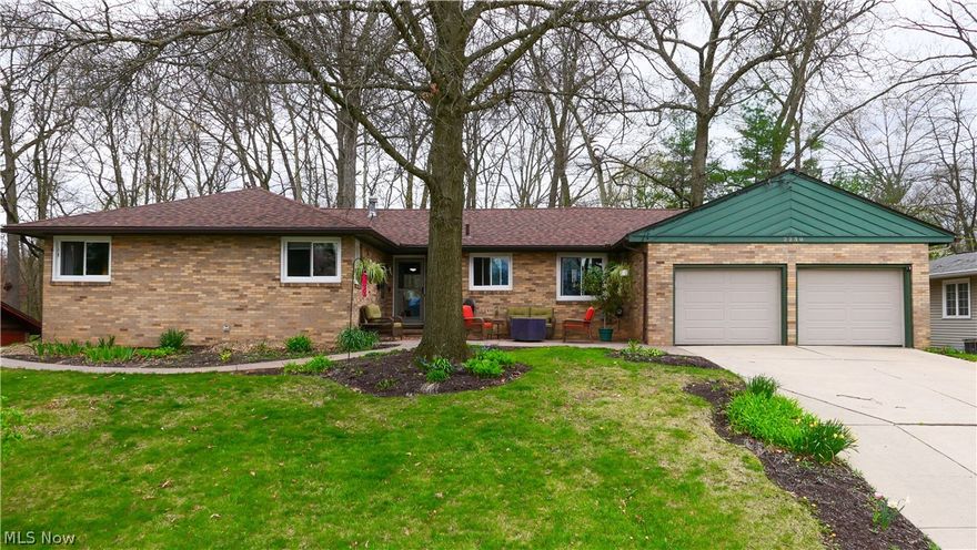 Updated, 3 bedroom ranch located in Cuyahoga Falls, which boasts a beautiful lot with plenty of outdoor entertainment and relaxation areas. As you approach the front door, you are welcomed with a stamped concrete patio providing you with a picturesque view of the neighborhood. The stamped concrete path leads you to the back of the property where you'll find a deck and additional patio space. There is also a gas grill, which is hooked up to natural gas.

The home features an open-concept living area with large windows that allow natural light to flood the space. The center of the home showcases a spacious kitchen complete with a huge custom island featuring beautiful solid surface counters. The island includes a gas stove and a breakfast bar. There is an office area tucked away off the kitchen. The dining area has custom built-in cabinets and leads to the separate family room, which features a wood-burning fireplace.

The bedrooms are nicely separated from the living areas. The master suite includes two large closets with sliding barn doors, a separate shoe closet, and an updated master bathroom. The updated hall bathroom is located near the other two spacious bedrooms.

The basement offers a huge finished area that includes a built-in entertainment wall, a pool table, and separate built-in banquet seating. The laundry room provides plenty of room for storage, and a small workshop completes the basement.

Updates to the property include all new windows and back door (2021), a new roof and gutter guards (2023), fresh paint throughout (2023), reinforced basement walls with sealant to prevent water intrusion with a lifetime warranty (2024).