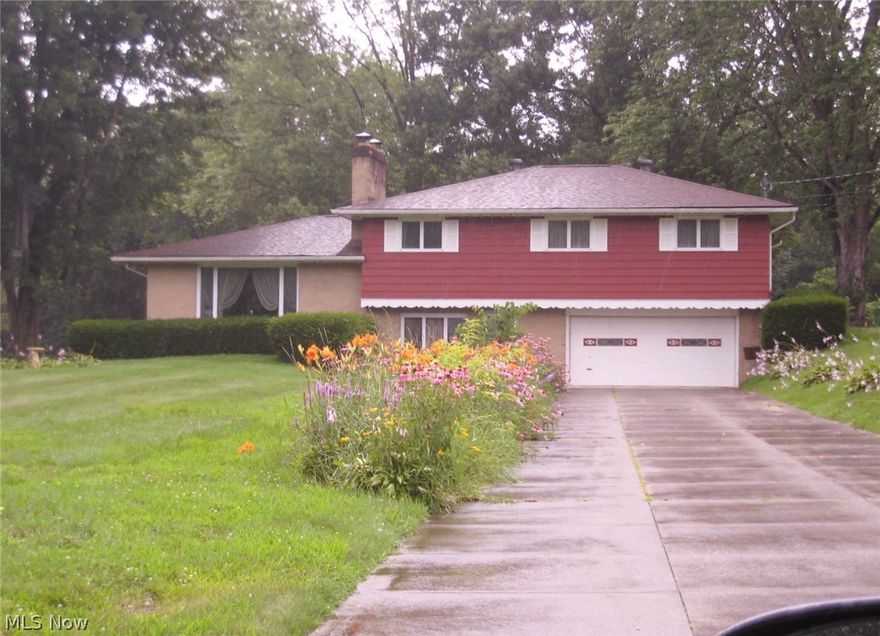 This lovely large 4 level split home sets on a 1.21 acre lot in a lovely, quite neighborhood and backs up to woods.  This pristine home has 4 bedrooms and 2 and a half baths. The large entrance room that could be an office, 1st floor. laundry, and 1/2 bath.  Large master bedroom, walk-in closet, shower, bath and 3 additional bedrooms and full bath.  The home offers hardwood floors in main area living room with fireplace, dining area off kitchen and door to deck and back yard.  Lower level is totally finished with bar and sink, fireplace.  Updates include baths, kitchen, well pump, 2014, roof 5 years.  Septic replaced 8/15.  Home warranty and one car detached garage.