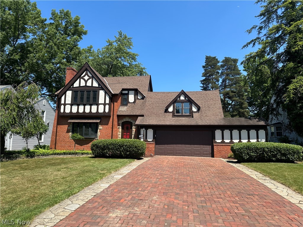Welcome to this classic tudor style brick colonial situated on a quiet tree lined street. Many recent updates include interior paint, new carpeting, updated kitchen & baths. The extra wide brick driveway leads to the gracious front entry with an arched doorway, coat closet and convenient first floor powder room. The formal living room has beautiful hardwood flooring, a charming bay window and cozy wood burning fireplace. Ideal for entertaining family and friends, the formal dining room has hardwood flooring and built-in cabinetry for storing family treasures. There are two sliding wood doors that open to the comfortable family room with brand new carpeting and a delightful bay window overlooking the private fenced back yard. The well equipped kitchen has engineered hardwood flooring, new stone counter tops, ample cabinetry, stainless appliances and plenty of room fo casual dining. (there is an extra hot & cold water hook-up too!) All 6 bedrooms are found on the second floor. Five of them have soft new carpeting and the other has hardwood flooring, there are two full baths and generous closet space. The lower level includes the laundry room complete with washer & dryer. The side door entry off the kitchen leads to the oversized two car garage (three can fit!) and a door to the back porch/sunroom with a heater and window air conditioner. The lovely fenced yard completes this remarkable residence.