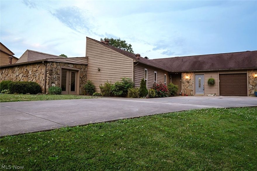 Location, Location, and Indoor Swimming Pool!!  This beautiful one-story mid-century modern (on the golf course with pond view) has an inviting blend of rustic and modern charm, with eye-catching knotty pine vaulted ceilings, stone fireplaces, and view of the pool from interior windows.  Home boasts 4-5 bedrooms and baths. Large eat-in kitchen with pretty cherry cabinetry, built-in china cabinet, countertop range, in-wall oven, pantry, and plenty of space! The home has a split bedroom plan - master with vaulted knotty pine ceiling and remodeled master bath with walk-in shower.  The second and third bedrooms and an updated bath are located on a separate wing.  The first-floor living room, dining, and kitchen all have a gorgeous view of the pond, backyard, and golf course, as does the large lower level family room and walk-out recreation room!! The lower level also offers a 4th bedroom and bath, a guest room or office with en suite, and a music room/studio.  Enjoy relaxing on the deck outback or the patio below and taking in the breathtaking views. One car attached garage on front and entrance to a 2nd lower level integral garage from the side with right of way.  Many updates in this home including all new windows, bathroom remodels, new flooring in most of the home, sliding doors, rear decking, and more.  Rare opportunity just waiting for you!! Room sizes are approx.