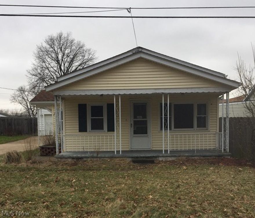 Addorable 2 bed/1 bath home with an inviting front porch, a lovely kitchen with crisp white cabinets, wood and carpet flooring, and an oversized & detached 2 car garage.