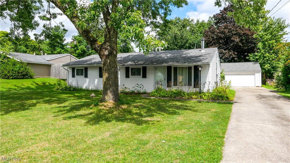 Welcome to one of the largest ranch homes in the neighborhood—double the size of the average ranch on the street! This spacious home features brand new carpet, fresh paint, updated light fixtures, and new mini-splits for year-round comfort. The oversized living room is perfect for gathering, while the custom-windowed kitchen and dining area offer an abundance of counter space, four lazy Susans, a slide-out silverware drawer, and a decorative oven hood—ideal for entertaining. Three generously sized bedrooms and two full baths provide plenty of living space, with the primary bedroom offering direct access to one of the full baths. A versatile bonus room at the back of the house features built-in blinds and leads out to the partially fenced backyard, making it perfect as a sunroom, office, or extra bedroom. Additional highlights include built-in shelving off the living room that could serve as a dining or office area, a hidden storage pantry, and double-pane windows throughout. The large mudroom with double closets offers incredible functionality and organization. Outside, you’ll love the heated three-car detached garage with a workshop and even more storage—an amazing space for hobbies, projects, or extra vehicles. With storage galore and thoughtful details in every corner, this home truly stands out.