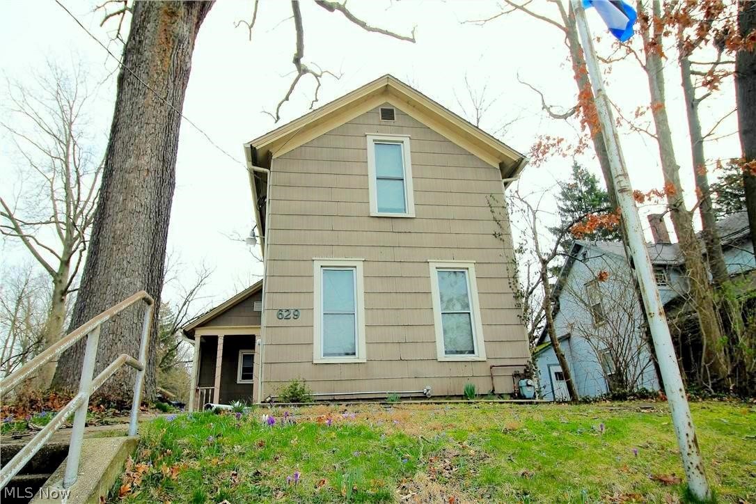 Investors! Welcome to this fabulous rental opportunity offering four bedrooms, two full bath colonial home. The first floor offers so much such as a first floor master bedroom with bathroom, 2nd bedroom with bathroom, laundry area, living room, dining room and kitchen. The kitchen has oak cabinets, appliances, plenty of room for a eat in area, and window to let the natural light shine through. The upstairs offers two more bedrooms with a full bathroom. There is a full basement. The large fenced in backyard has a fabulous patio area for everyone to enjoy. There is a rear separate building which would be great for an artist workshop, music room, etc., does have heat, and there is a storage shed in back of the building. Basement wall replaced in 2008. New chimney rebuilt. Newer 50 gallon HWT, newer electrical and panel. Newer PVC plumbing. The fridge is about 3-4 years old and the dishwasher is about 6 years old. Very close to downtown Kent and Kent State University. Tenants currently