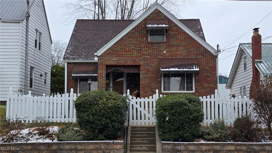This charming cottage is freshly renovated and move-in ready!  Conveniently located on Broad St, this home is fully clad in brick ensuring low exterior maintenance and plenty of curb appeal.  The wood picket fence is as functional as it is charming- freshly painted and enclosing the front and back yards.  An inviting front porch greets guest from on street parking, and leads into the living room with hardwood floors and a fireplace.  Just to the right, a large eat-in kitchen has been completely updated with new cabinets, countertops, tile backsplash, LVP flooring, and is appointed with a stainless appliance package.  The main level also includes two bedrooms with new carpet, and a full bath- also completely renovated with stylish Kohler fixtures and a tile shower surround.  Upstairs is a third roomy bedroom with a large closet and ample natural light.  A large attic space accessed from this space offers a great storage solution for holiday decor, seasonal clothing, etc.  The basement has a large room that could easily be a fourth bedroom, gym, office or more storage.  There's a large pantry type space near the bottom of the stairs for stocking up on food and cleaning supplies, and the laundry area is roomy and functional, with a convenient utility sink.  A brand new bathroom with walk-in shower has also been added to the basement as well.  Out back, the yard is large enough for kids or pets, and small enough to maintain easily.  A detached garage and carport are accessed from the alley, making for plenty of convenient parking for the owner(s).  With updates such as fresh paint throughout, repainted garage, all new interior and exterior lighting, new landscaping, one year old furnace, and a roof only 2 years old, this home has all the big ticket expenses already covered!  Located near city park, and convenient to shopping and dining.  Schedule a showing to see how this charming cottage could be perfect for you!