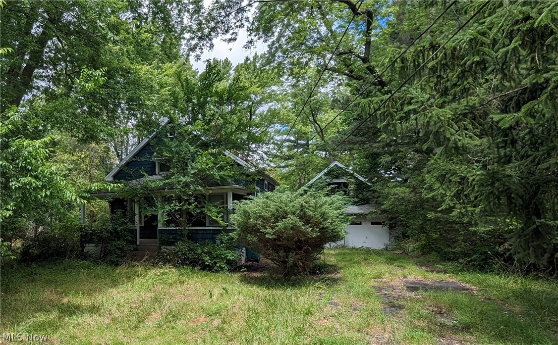 INVESTMENT OPPORTUNITY on just over 2 acres! This charming bungalow offers 3 bedrooms and 1 1/2 baths. Two detached garages on the property.
