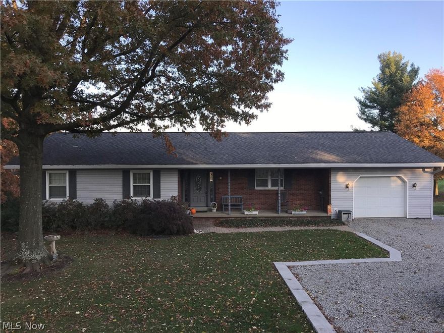 Gorgeous views in this 3 BR 2 Full Bath one of a kind brick ranch home. Sun Room on top level, walkout fully finished basement which has a full kitchen. 1 car attached garage with additional 2 car garage that includes a workshop. Beautifully landscaped with newer retaining walls and stone. This home is in a great location with endless views of the countryside. Downstairs living area with walk out to patio, perfect mother in law suite.  There are newer gutters and downspouts with screen and a reverse osmosis system in the home. Brand new Schrock kitchen coming soon!  Enjoy the views and the wildlife from your living room, country living close to I-77 and SR 39, not far from town!