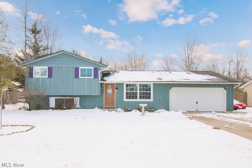 Welcome to this lovely split level home located on .70 acres in the heart of North Ridgeville.   The open floor plan features a gorgeous eat in kitchen boasting a large morning room, cherry cabinetry with tile back splash, fantastic breakfast bar and sleek stainless appliances; which stay.    Three bedrooms and a full bath complete the second floor.  The lower level family room currently being used as a bedroom features custom molding, wood floors and a wood burning fire place. The Amazing lot is ready for summer with deck and pool.  Newer windows and doors throughout and newer flooring on main level. You don't miss this one, call today for your private tour.