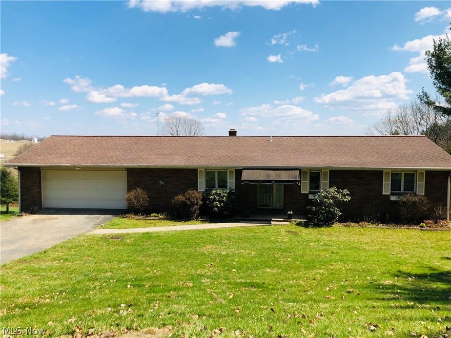 Spacious brick ranch home, 4 bedrooms and 2 full baths with a perfect location that is out of town but close to schools, grocery stores, mall and I70. Large well lit living room and attached dining room.  Spacious eat in kitchen with updated flooring and access to attached 2 car garage for easy unloading of groceries. 2 nice size bedrooms and a full bath complete the main level.  Loads of room in the lower level with 2 additional bedrooms, a large recreation room, a gas fireplace and access to a covered rear patio and deck for relaxing, entertaining and grilling. Large media/game room with a built in bar and lots of storage room. Home Warranty