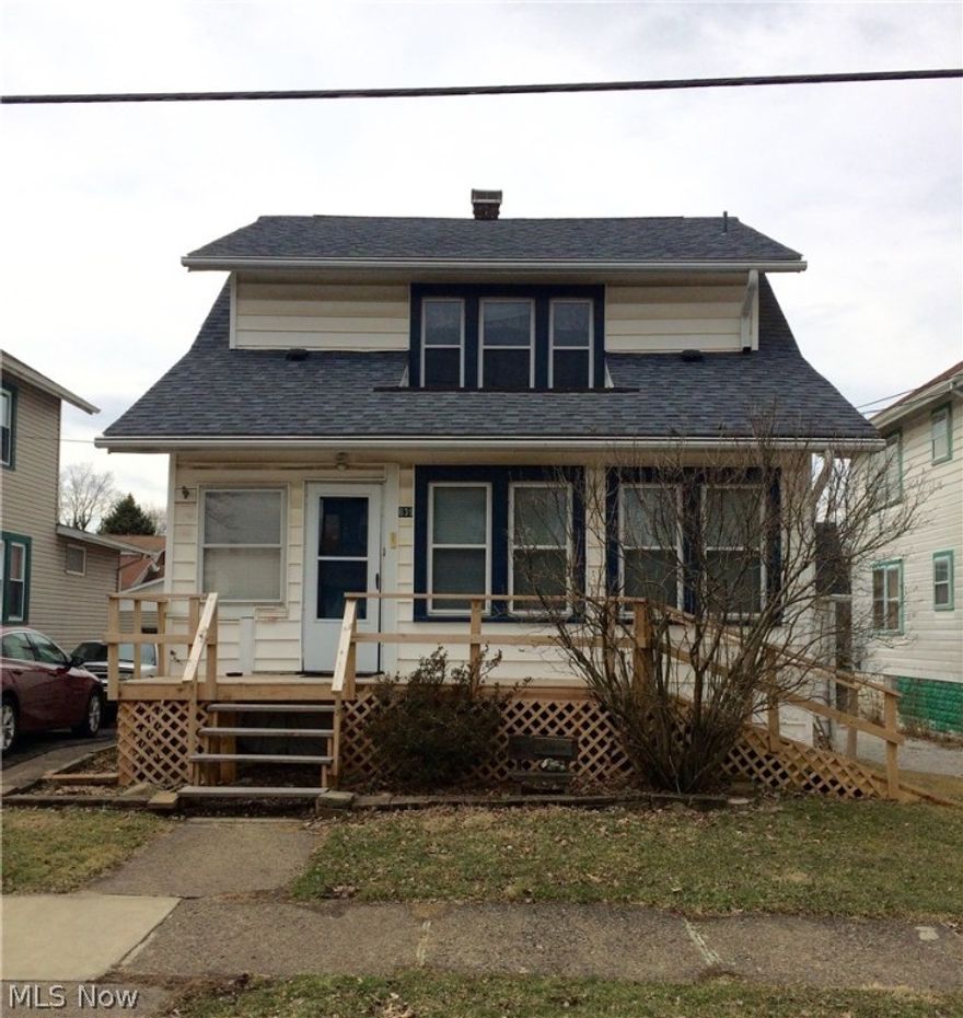 If you have been looking for a large home, love natural wood flooring and optimal bedroom & baths ~ TAKE A LOOK AT THIS HOME!  With 6 bedrooms- including the first floor master - and a full bath on each floor.  This home offers plenty of living space.   Nice large living room with fireplace and beautiful French doors into the dining room.  There are 3 bedrooms upstairs and a pull down for attic access (great storage area).   The lower level has a private entrance to another living area.  This area includes a living room with decorative fireplace, a kitchen, 2 bedrooms and full bath.   It can also be accessed from the main part of the home.   The oversized 2 car garage is rumored to have once been the carriage house!   There is a fireplace and stairs to a storage loft.