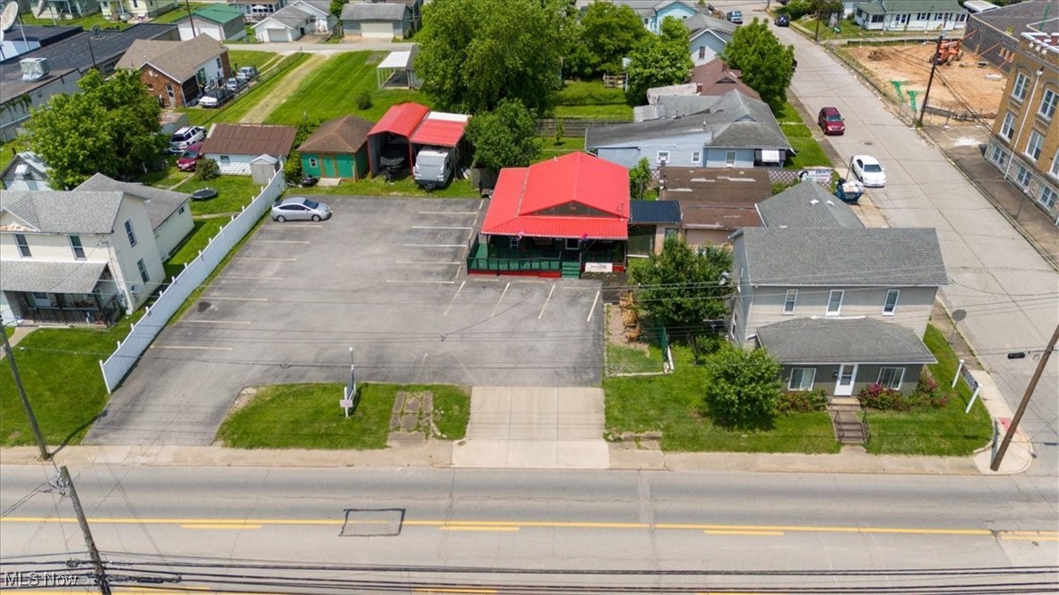Seeking a distinctive opportunity to relocate your existing restaurant or establish a new one? This one property offers the opportunity to have both commercial and residential income streams! Generate rental income from a 3-bedroom, 2-bath house and the separate salon located right next door to the restaurant. This property has endless possibilities and is in a prime location for both locals and visitors. Just minutes away from I-77 and Route 50! From approximately 1,000 sq. ft. of dining room and table space, a 37x12 ft. commercial kitchen equipped, and a salon that has enough space for 3 rental booths. The restaurant is set up for both indoor and outdoor seating, and plenty of parking on a nicely paved parking lot. You will also find a large storage building along the back of the parking lot as well! Come check out all that this corner lot along 7th Street has to offer!