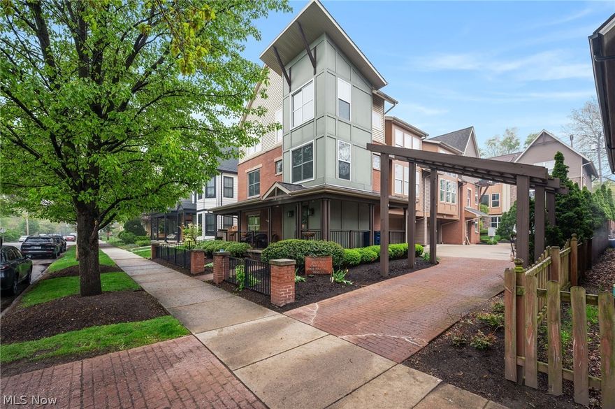 Live on one of Ohio City’s most photographed historic streets!! This standout property is located in a beautiful, walkable, tree-lined setting surrounded by a blend of timeless century homes and thoughtfully designed newer construction. A custom steel handrail gracefully spans from the first floor through the upper levels, guiding you as you move through the home and serving as a defining architectural element that establishes its modern aesthetic from the moment you arrive. This updated 2-bedroom, 2.5-bath townhome offers the perfect balance of character, location, and modern comfort. The main floor centers on a massive great room featuring a contemporary gas fireplace, soaring ceilings, and expansive windows that fill the space with natural light. The fully renovated chef’s kitchen is a standout, complete with quartz countertops, a large island with breakfast bar seating for four, high-quality soft-close cabinetry, double wall ovens, and abundant storage. Adjacent to the kitchen is a spacious dining area that comfortably seats six. Just off the kitchen and dining area, a full wraparound butler’s pantry serves as an extended entertaining space, featuring a wet bar and wine fridge ideal for hosting larger gatherings, serving, or expanding your prep and presentation area with ease. Flexible living spaces include dual owner’s suites and two loft areas, one of which could be easily converted into a third bedroom. Additional highlights include multiple outdoor areas, including a wraparound front porch, a private composite deck, and a fenced yard with a patio and dog run. A bonus is the potential to create a rooftop deck, which could capture stunning lake views and further enhance the home’s outdoor living experience. Recent updates include major kitchen and flooring improvements, A/C, water heater, porch railing, deck privacy wall, and newer front windows. Just 1.5 miles from downtown Cleveland, with walkable moments from all that Ohio City and Hingetown have to offer.