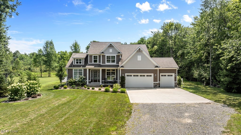 Without the wait of building from scratch, you can enjoy this custom-crafted 2020 home on over 2 scenic acres in Bath Township and the top-ranked Revere School District! A private driveway stretches through mature trees & fresh landscaping to a beautifully designed home that offers space and seclusion. Out back, a heated saltwater pool, expansive stamped concrete patio, and 20x12 gable-covered deck are surrounded by lush greenery. It’s a resort-style setting perfect for quiet mornings or lively gatherings. A covered front porch welcomes you into the light-filled interior with soaring ceilings, scenic views, and effortless flow. At the heart of the home, the great room features a stone fireplace and dramatic wall of windows. The chef’s kitchen boasts elegant cabinets, a grand island, and a wet bar with a beverage fridge & mounted TV. Discreetly tucked behind the cabinetry, a butler’s pantry adds both storage and surprise! The kitchen is flanked by a bright morning room (at the back) and a home office (at the front). The first-floor primary suite offers a coffered ceiling, dual vanities, water closet, stately tile shower, and a spacious dressing room. Laundry on the main floor adds everyday convenience with a deep sink, storage & ample counter space. A stylish powder room sits off the 3-car garage entry. Upstairs are 2 generous bedrooms with walk-in closets, a full bathroom with dual sinks, and a 14x12 versatile loft. The lower level features a 27x11 rec room with rubber flooring, speakers, a mounted TV & storage nook. A contemporary full bath was added in 2023. Whether you envision a home theater, guest suite, creative studio, or more, this basement provides a solid head start. Other updates include new garage floors, low-maintenance gutter guards, and fencing that encloses the backyard and pool. Every inch of this property reflects quality craftsmanship, smart planning, and timeless style all in a location that checks every box. YOUR happily-Everett-after awaits!