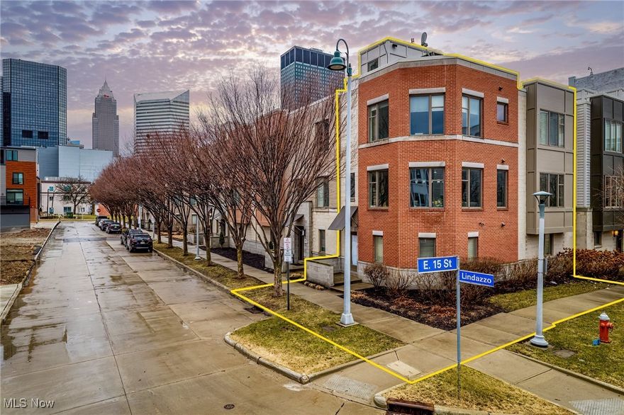 Experience the best of urban living in this exceptional Henry Wicks townhome, perfectly situated in the vibrant heart of downtown Cleveland. A short stroll away from Playhouse Square, all of Cleveland’s professional sports stadiums, Heinen’s grocery store, CSU, Lake Erie fronting Voinovich Park and so much more!!!  This special END unit has beautiful curb appeal with a brick and stone facade. Step inside and discover an impressive interior boasting gleaming hardwood floors, expansive windows and an open floor plan designed for effortless entertaining. The bright and airy ground-level living space could easily serve as a third bedroom or expansive office or flex room. On the primary living floor, find a sleek kitchen proving to be a true chef’s dream! White cabinetry, stunning light granite countertops, high-end stainless steel appliances, and convenient island seating make it ideal for casual gatherings. Stylish built ins frame the dining area which flows to the inviting living room. Elegant crown molding and a tastefully designed stone gas fireplace are highlights of the living room. Retreat to the bedroom level and find two generously sized bedrooms each with an attached full bathroom for added privacy and convenience. The primary suite bathroom has an enormous walk in frameless glass door shower and beautiful tile work.  Don’t forget the roof level! Catch the Lake Erie summer sunsets or the Cleveland air show on this roof deck that has 360 degree views.  This corner unit also boasts a two-car garage located at the rear, providing easy access and ample parking. Don’t miss your opportunity to call this exquisite townhome your own.