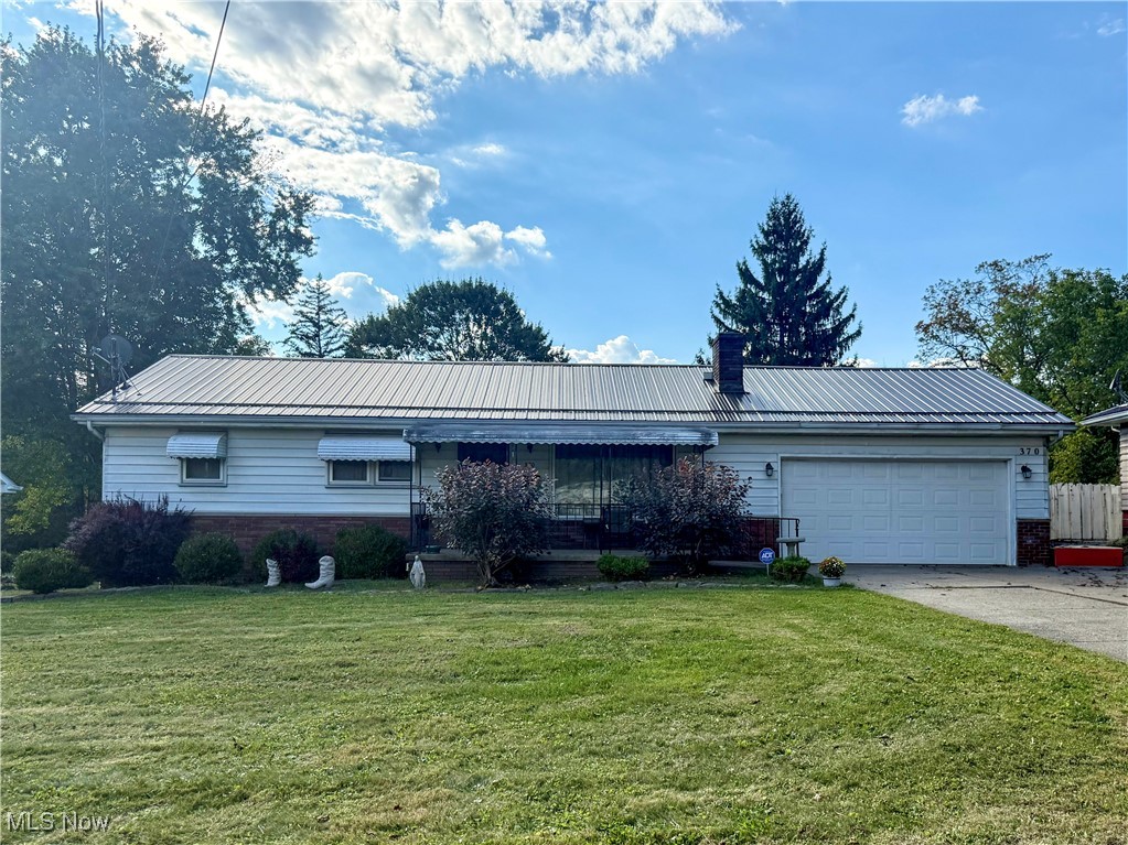 Welcome home to this updated 3-bedroom, 2-bathroom ranch nicely situated on a .77-acre lot with picturesque views of the trees and stream that runs through the back of the property. Important updates include a newer metal roof, furnace, hot water heater, AC unit, and some vinyl replacement windows. There is a nice cement patio off the back, along with a spacious enclosed porch - both are prime spots to enjoy the expansive backyard and its wildlife visitors. An oversized concrete driveway leads to the two-car attached garage, providing ample parking and storage options. The house also includes a security system through ADT with monthly monitoring. All this in a convenient location near shopping, dining, and schools. Best of all, you can enjoy hiking, rock climbing, biking, boating, and picnicking in nearby Mill Creek Park. Don't miss out! Schedule a tour of this delightful house today.