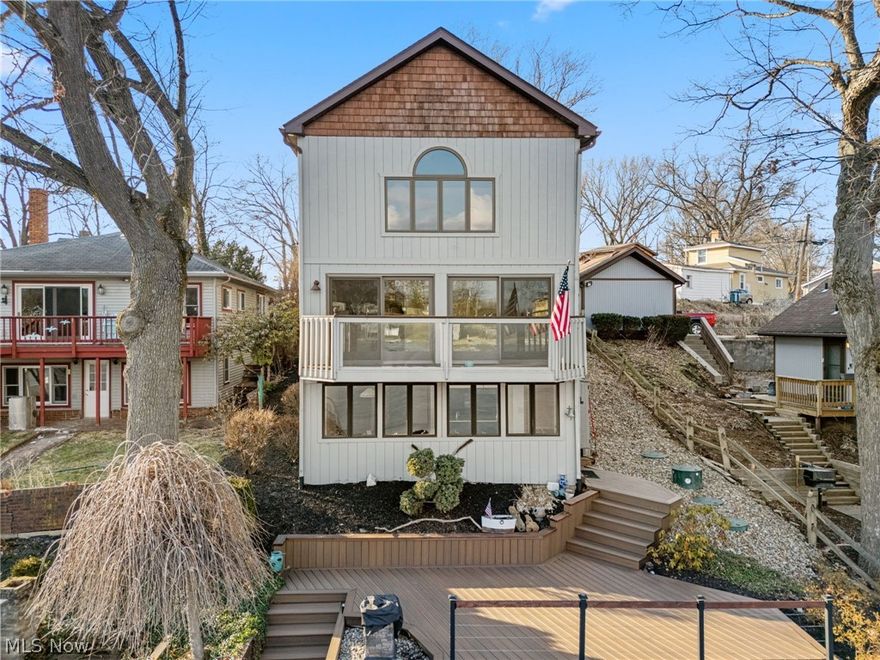 Finally make your lakefront living dreams come true with this one-of-a-kind 3 bedroom, 3 bathroom home on the Portage Lakes! Conveniently located on the West Reservoir of the Main Chain, you're just a boat ride away from all the fun this community has to offer. Upon entering, you'll immediately notice the living room's vaulted ceilings with panoramic windows, giving you tons of natural lighting and beautiful views of the water. The sliding glass doors are a great way to allow a lakeside breeze into the home, and they open up to a balcony that makes you feel as though you're standing directly above the water. Down the hall, you'll find a bedroom with an en-suite full bathroom which rounds out the main level. The kitchen and dining room is located on the lower level which is a perfect use of space as you'll have lake views while you're cooking, eating dinner, or entertaining guests on the back deck! There’s a bonus room which could function as an office space, additional storage, or a spare bedroom and a full bathroom for added convenience. Upstairs, you’ll walk into the primary bedroom with a massive walk-in closet and a spacious en-suite bathroom which features a jacuzzi tub. Imagine falling asleep to the sunset off the water… this is possible if you use the loft space for a third bedroom! The backyard has been meticulously maintained and includes composite decking, electricity, gas fireplace, and room for hosting. Are you ready to finally start or upgrade your lake life? Call today to schedule your private showing.