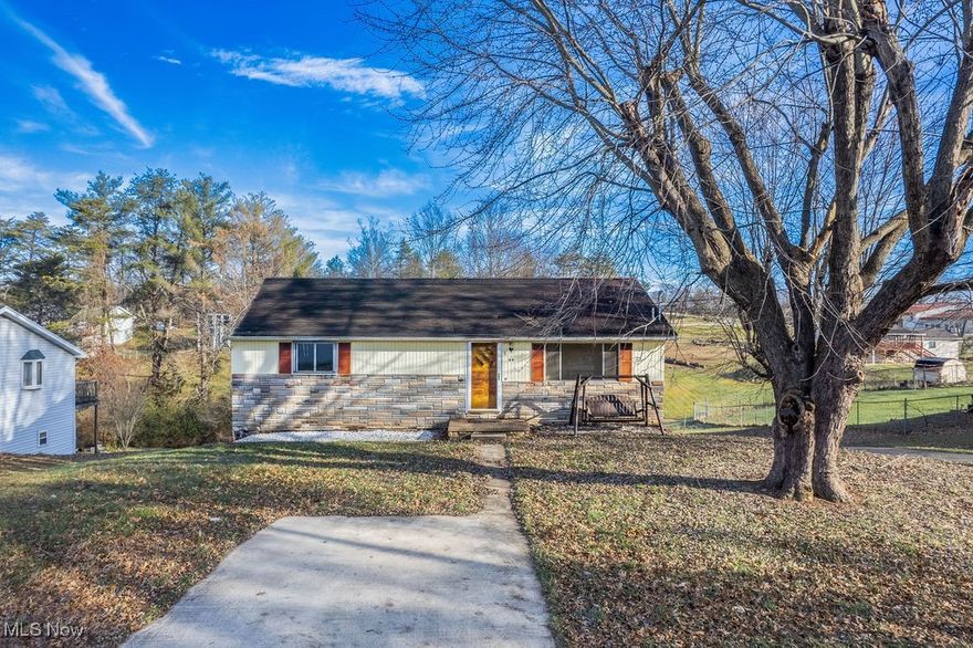 Keep on the sunny side of life with this Sun Street home!  This 3 bed 2 bath midcentury ranch sits on 1/3 acre in Lubeck.  The stacked stone accent on the front adds to the curb appeal, and a front parking pad makes for convenient entry for guests or owner.  The driveway leads down to an attached garage in the basement for comfort, convenience, and security.  Inside, original hardwood floors carry through most of the main level.  A large front living room has plenty of natural light, and a roomy eat-in kitchen sits just behind.  Down the hall are three bedrooms with ample closet space, and a full bath with original midcentury charm.  Downstairs, a finished rec room has a large built in wet bar and a half bath for convenience.  A large utility room includes laundry, and plenty of space for storage, and is accessible from both the rec room and the garage.  The Lubeck Fire Department's community park is conveniently nearby to enjoy it's walking trail and pavilions.  Elementary school, banking, and shopping all available within walking distance.  Schedule a showing and see how this ranch home could be perfect for you!