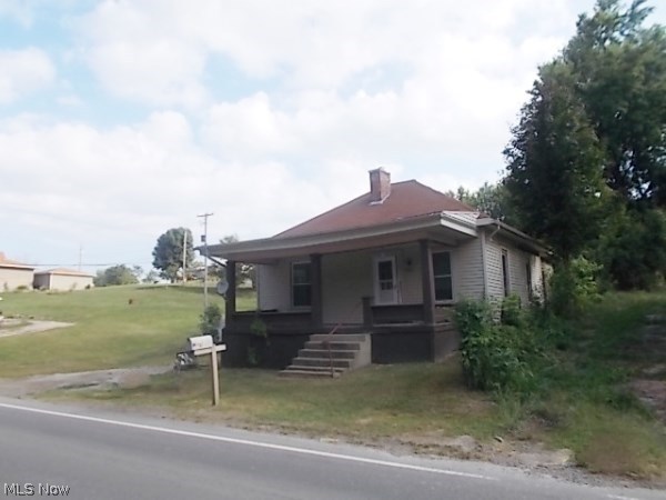 Attention Home buyers this Affordable country like setting home features 3 Bedrooms & 2 Bath. Very Large side and back yard that should not be overlooked. Fenced in back yard area perfect for animals and children to play. 2 detached garages and gravel drive provide ample parking and storage. One with new metal roof. This 1 story home also features Dining area, Updated Kitchen, Newer flooring throughout. Vinyl windows, siding, and newer roof on the home as well. One with new metal roof. Just right outside of town with a feel of country living and near town for all the amenities. Investors this home has great rental history and could quickly become an income producing home. A must see! Home Warranty included with purchase!