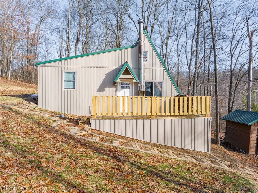Tucked away on 2 mostly wooded acres, this recently remodeled A-frame cabin has rustic charm. Updates on this property include new siding, a new door, new porch and new water well in 2025. Inside, a cozy wood-burning stove anchors the open main living area, creating a warm and inviting space. The rear of the cabin features a functional kitchen, including a new fridge, and full bathroom, with a loft above that adds character and flexible sleeping or storage space. An addition expands the footprint, offering a bonus room that can serve as an extra bedroom, office, or recreation area. Step outside onto the wood deck and take in peaceful views of the surrounding woods. Or, hunt from inside the cabin, which is what the previous home owners did with success. With its own well and septic, electric hot water heater, and electric baseboard heat, this property offers a private, self-sufficient retreat ideal for a weekend getaway, a hunting cabin, or full-time escape.