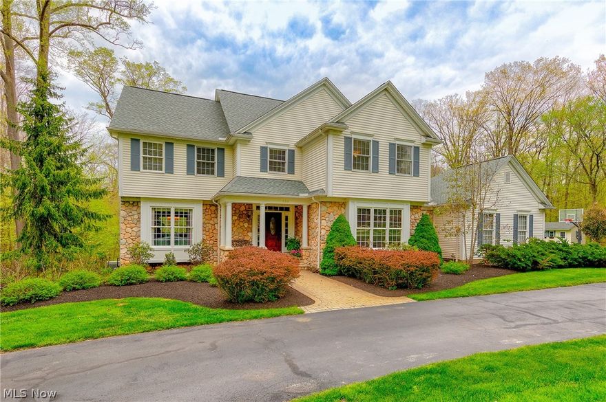 Welcome to this one owner home on a majestic lot handcrafted by Mother Nature herself. This gorgeous colonial, nestled on over three acres, is professionally landscaped and designed into the contour of the land. Enter the spacious two story foyer and be welcomed by the two-sided staircase and the natural cherry wood floors and trim that was harvested from the property! The entertaining flow is fabulous as the formal living room opens to the formal dining room complete with crown molding, chair rail, wainscoting & bay window seat overlooking the rear grounds. The gourmet kitchen is a chef's dream with natural cherry cabinets, double ovens, huge island, and tons of granite counter space. The kitchen opens to the great room with vaulted ceiling & wall of new windows cascading light into the home.  Conveniently also on first is a den/office connected to a first floor full bath. 9' ceilings throughout the first floor all with rich deep natural moldings. The master suite is a delight with gl