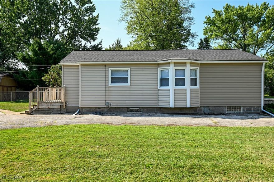 Look at this absolutely charming Ranch home in Sheffield Lake! Move Right In! This beautiful home offers two spacious bedrooms, one full bathroom, an oversized kitchen with dinette area and a wonderful living room with plenty of natural light! Enjoy cooking in this beautiful kitchen with plenty of cabinet and countertop space! Stove and refrigerator stay! Enjoy the Lovely Eat-In kitchen area with ceiling fan and an outward extended triple window wall and beautiful view! The Living Room has plenty of space, an oversized front window allowing lots of natural light, a ceiling fan and newer carpet/paint! Updated full bathroom with lovely vanity, fresh paint, light fixture, mirror, toilet and chrome hardware in shower! Primary bedroom offers walk in closet with a large additional closet/storage area! Updates include: fully painted interior, some light fixtures, retextured ceilings, laminate flooring in kitchen/eat-in kitchen and bathroom, newer carpet in living room and bedrooms, updated electrical panel, glassblock windows, newer interior doors throughout and blinds! Full, unfinished basement, waterproofed perimeter- can be made into your own recreational room! Washer and dryer stay! One minute from the lake with lake access! BONUS: Double wide lot! Perfect for outdoor activities or for watercraft housing/boat! For this area, This property offers a rare TWO car garage with plenty of storage space! Extra-long driveway with turnaround area! Cozy back porch! Vinyl Siding! Hurry this will not last long! Selling As Is.  Close to Lake Erie, shopping, hospitals, freeway access, restaurants, parks and more! Contact us today with questions or to see!