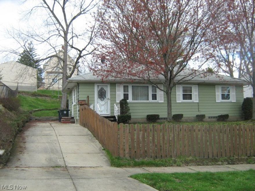 Why rent? Priced below appraised value and much less than rent! Step-saving ranch with beautiful new living room, dining room and hallway carpet (hardwood underneath).  New tub surround and freshly painted bathroom.  Handsome wooden kitchen cabinetry.  Attractive knotty pine paneled rec room with bar (bar stools included).  Ready to move right into! Easy access to I-76 - I-77, close to downtown.