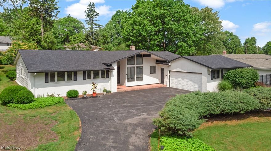 Welcome to this exceptional 4/3.1 2560 sq ft ranch-style mid-century home. Boasting a unique blend of eclectic original work & timeless charm. As you enter, the impressive 2-story grand foyer captivates with its dramatic presence. Adorned w/marble flrs & robust wrought iron panels that frame the foyer, giving a hit of distinctive character. Discover a spacious sunken Great rm/dining rm, featuring etched glass accents & soaring cathedral ceiling creating a sense of grandeur & openness, while a magnificent wall of windows floods the rm w/nat light, offering a picturesque view of the surrounding landscape, where you're drawn to the unique architectural details, & the abundance of nat light. Among the seamless blend of mid-century design is a paneled den w/built-ins & wall of sliders leading to a private oasis w/patios. Picture a mid-century Eat-kitchen that exudes functionality, clean lines, subzero, wall ovens, w/cathedral soaring ceiling & wall-of-windows, creating a sense of spaciousness. Private Primary w/en-suite, 3 more nicely sz bdrms & full bath completes the bedroom wing. Powder room exudes vintage charm, oversized laundry rm goes beyond the traditional concept, offering ample space to make household choirs a breeze. Lower level is finished with a bathroom. This home boasts Newer roof 2022, newer gutters, bdry 2016. 2+ car garage & circular driveway. This home is a sanctuary that provides all the essential elements, space & structure to curate an atmosphere of unparalleled quality, style, tranquility and harmony in the modern age. This home is eagerly awaiting the transformative touch of your personal imagination. Enjoy, sidewalks, Beachwood Aquatic Center, Playground, Community gardening, Community center ,shoppes, eateries, easy commute to Cleveland Clinic, UH,  YouTube click 3D video