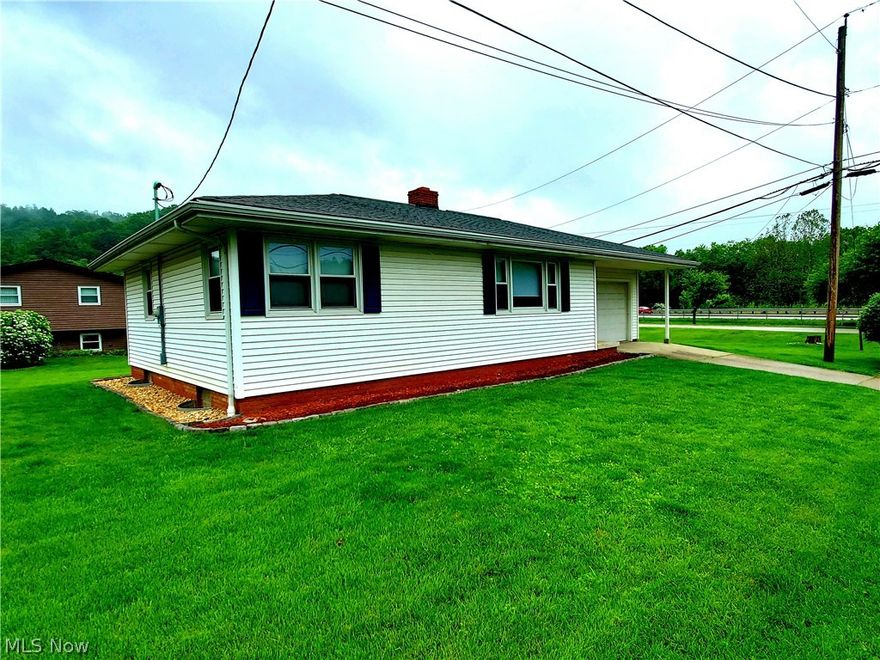 FLORAL VALLEY...at the North end of Martins Ferry and only about one minute to Ohio Route 7!! This "MOVE IN READY" 2 bed, 2 bath Ranch Style home with a 1 car integral garage and nice landscaping is ready for a new owner!! CLEAN & COZY with a nice flat yard, covered entry and concrete driveway. The living room has a GORGEOUS BRICK FIREPLACE and the kitchen has PLENTY of storage in the beautiful cabinetry! The adjoining dining room allows for more guests! UPDATES...  flooring, new shower surround, light fixtures, smart thermostat and fresh paint. CHECK OUT the AMAZING COVERED back patio....OH YEAH!!! Let the grilling begin!! The lower level offers the laundry and a nice large partially finished area for working on projects/crafts or just needing extra storage space. HOME WARRANTY! CALL TODAY!