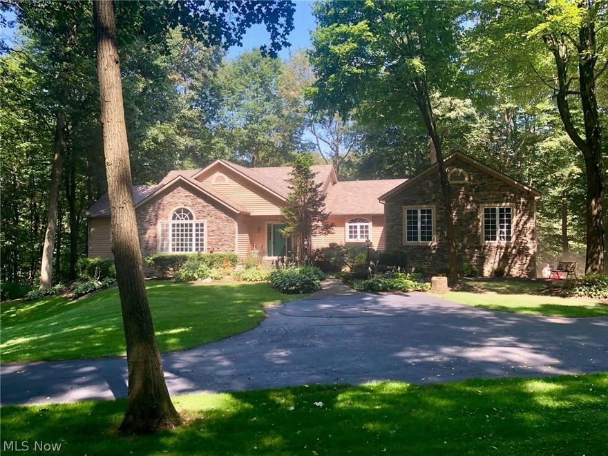 Recently renovated with new ProVia windows, interior paint, and some carpet!  Don't miss the opportunity to own this custom built ranch home nestled away on a private wooded lot just minutes from town!  Surrounded by green space, the park like setting offers you a peaceful privacy.  The home potentially has 3 master suites, 4 full baths, an open floor plan, finished above grade lower level, 4 car garage, and a beautiful 4 seasons room to enjoy nature.  With almost 5000 sq feet of finished living space, there is room for all of your needs.  A huge private office with it's own private bath is ideal for those who work from home. There is an additional one acre lot adjacent to the property that can be purchase for $40,000. Located in the the private community of Woods of Wulamo.