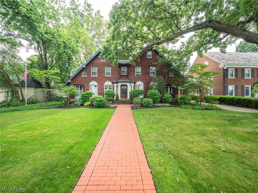 Location is everything, welcome to Edgewater North! This graceful center hall colonial sits on a tree-lined street with partial views of Lake Erie.  Mature trees, thoughtfully planted perennials and annuals surround this elegant home with beauty. After strolling up the brick walkway, enter a large foyer with original tile floors, crown molding and baseboards, hardwood flooring throughout and a classic center hall floorplan. Dining room to the left, living room and library to the right. Each room is framed with several 10-panel glass, floor to ceiling windows and doors which open to accept the refreshing lake breeze that flows from the front to the back of the home! The dining room flows into a large butler’s pantry, a timeless chef’s kitchen, and a breakfast nook.  The kitchen offers granite countertops and backsplash, shaker cabinets, subzero refrigerator, and bead board ceiling.  Adjacent to the living room is a comfortable and cozy library with a fireplace for the chilly fall and wi