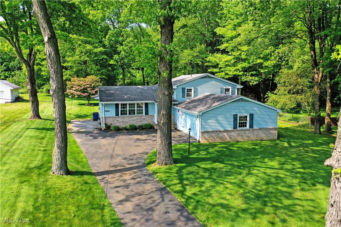 Find your paradise beneath the trees with this marvelous Brookfield spilt level home! Showcasing its sprawling, four level layout to include a large basement, this residence has it all and more. Instantly captivating with its bright blue colors and contrasting brick accents, good looks are found at every angle. Take in the scenic views as you enjoy the screened-in and covered rear porch, overlooking a bonus storage shed. Step inside the decorative front door to find an expansive living room, sweeping into the adjacent dining area with hardwood styled flooring. Sunshine spills through the trio of lattice lined windows for additional illumination. Revel in the masterfully lit kitchen as the cherry-colored cabinets and outstretched, stone-style countertops pair with natural brick design features. Upstairs, a formidable full bath offers private access to the master bedroom suite. Two additional bedrooms complete the floor. Down below, a gracious family room delights with a brick mantle with inset fireplace. A second full bath awaits nearby while a casual lounge area finished the package with a corner wet bar. Call today to be first through the door!