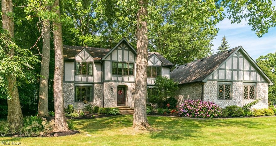 Beautifully maintained 4 bedroom tudor colonial in the desirable Woodlands Development . This home features an eat in kitchen that would delight any cook. It has been updated with granite counter tops, newer LTV flooring and has loads of cupboard space. The spacious formal dining room is adjacent to the kitchen for easy entertaining. Enjoy the warmer months sitting on the deck enjoying the private park like yard. Having friends over for game night? The large family room , which is accented by the gas fireplace and  tall windows, is the perfect room for that. Also on the main floor is the living room with french doors and plenty of natural light. There is also a home  office ,which is well separated from the main part of the house, giving privacy for those who work from home. A laundry room and mud room which leads to the attached  3 car garage and 1.5 baths round out the main floor. Upstairs you will find the master suite with large walk in closet and spacious master bath complete with soaking tub and walk in shower. Three additional oversized bedrooms and the third full bath complete the second floor. The full basement is partially finished and offers a rec room and space for exercising and storage. Additional updates include new Pella windows, HVAC that was installed in 2019, countertop range and refrigerator 2016, and the roof was replaced 2007.