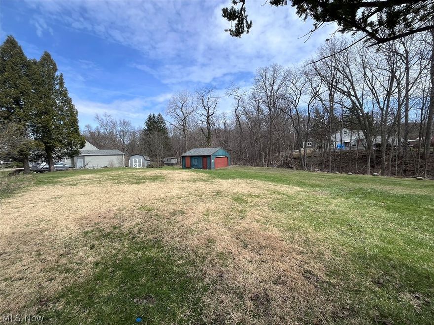 Don't miss this rare opportunity to build a contemporary residential ranch style duplex on a picturesque .72 acre lot in Bedford. Close to Bedford Reservation, which is a part of Cleveland Metroparks, shopping, and freeway access. A two-car garage (circa 2005) is already on the lot and just imagine an open floor plan with covered patio that looks out to a lovely wooded and private backyard! The offer includes digital building plans and a site map that had previously passed the first step of the city's building approval process. The footprint of the design has been cleared of trees, as well as extensive clearing of overgrown trees and shrubs near the garage, at the sidewalk, and at the edge of ravine.  Hookups to public water and sewer are already there.
The duplex's design is for 2,216 total square feet of living space (1,108 per unit) on a crawl space foundation and includes an open concept living room, dining room and kitchen filled with natural light; 2 bedrooms and 1 bathroom in each unit. The lot allows for ample parking space. Take the time to stop by this lot!