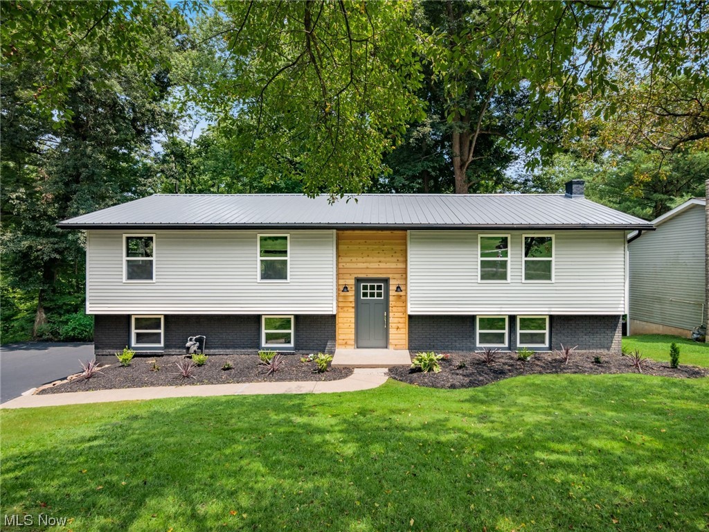 Quality work done in this completely remodeled home! New roof, new siding, new windows, new flooring, new paint, new kitchen, new bathrooms, new garage door openers & most drywall replaced. This home is located in West Zanesville in a quiet neighborhood on a dead-end street. The upper level has 3 bedrooms with the owner's bedroom having it's own full bathroom and a shared full bathroom. There is plenty of space in the living room and kitchen. You could set up the rooms for entertaining, utility, or a bit of both. There is a deck off of the kitchen overlooking the partially wooded rear lot. The lower level has a high ceiling in family room with a fireplace, closet & half bathroom with access to the garage or to the rear of the home. Spend your weekend backyard camping and not lawn mowing!