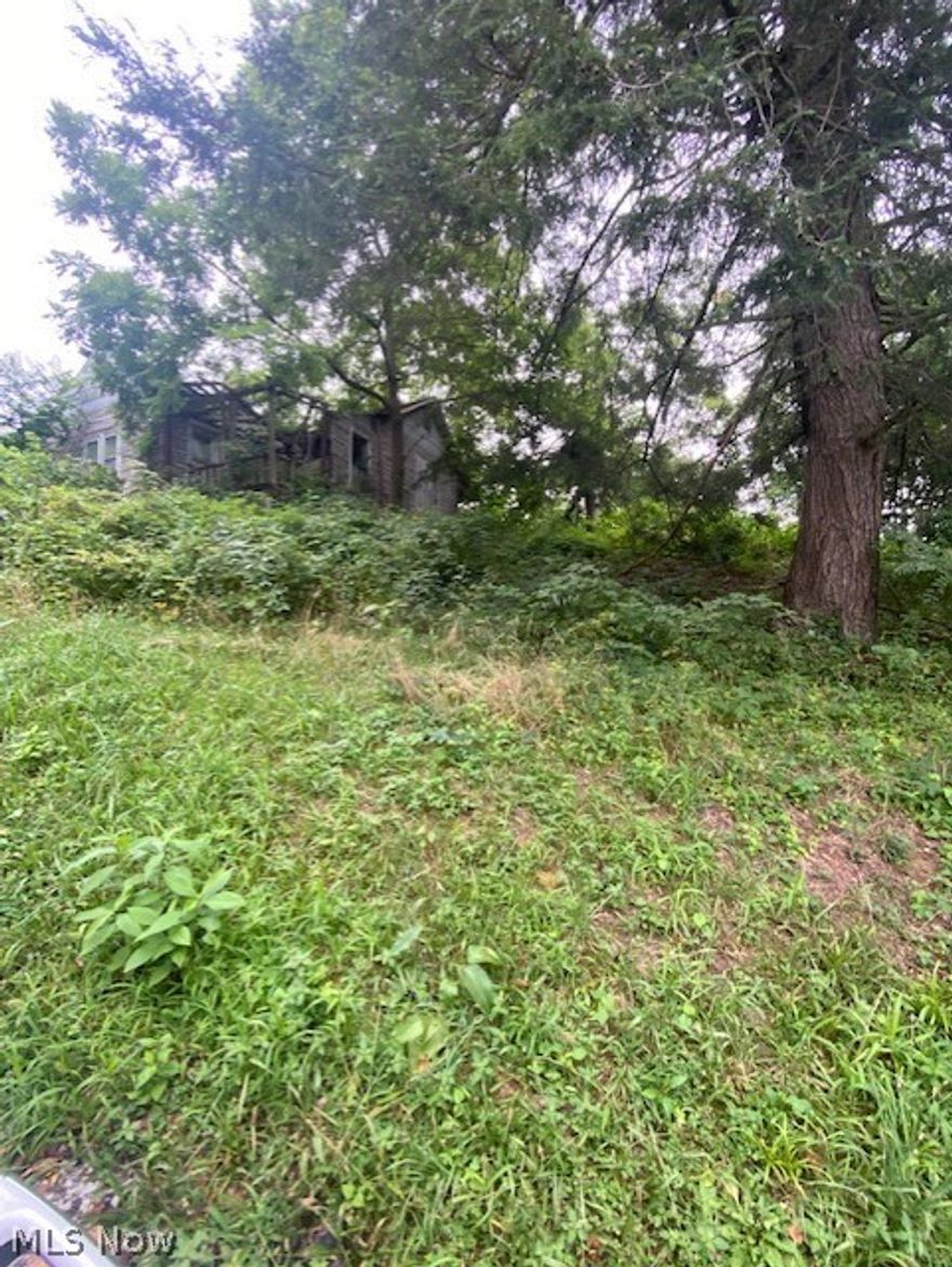 Property has old house that needs tore down.  Utilities on site, public water and sewer available, Lot is wooded.